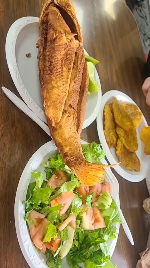 Crispy fish served with fresh garnishes.